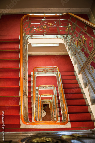 spiral staircase with red carpet
