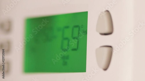 Digital thermostat used for heating and cooling - Energy expense and finance concept