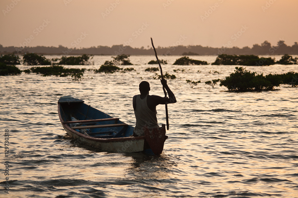 silhouette of a fisherman in the sunset, Senegal, Saloum delta