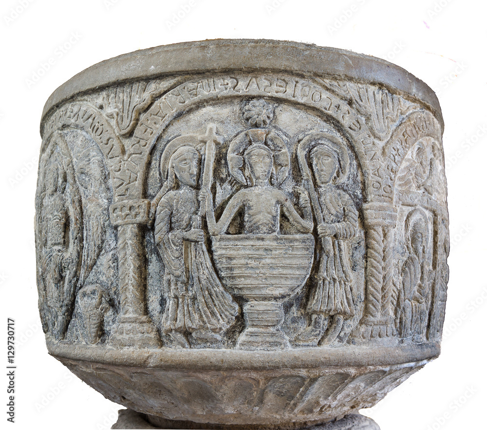 Medieval baptismal font isolated on white. A stone carving of the