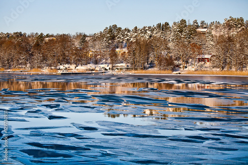 Sweedish landscape with frozen sea and winter sunlight near Stockholm photo