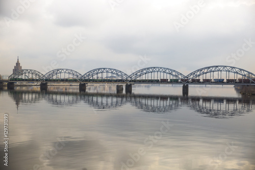 Picturesque view over the metal Railway Bridge over the Daugava river in Riga, Latvia