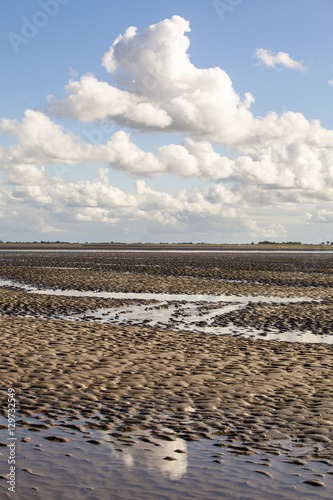 Maritime landscape with reflection of clouds in low tide water, Waddenzee, Friesland, The Netherlands