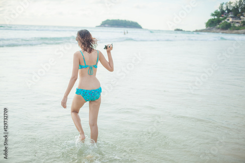 a lady walking at the paradise beach horizontal