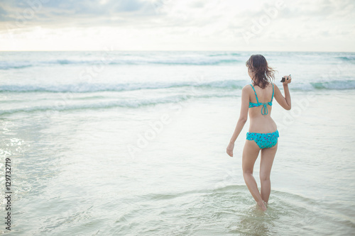a lady walking at the paradise beach horizontal © loliloop