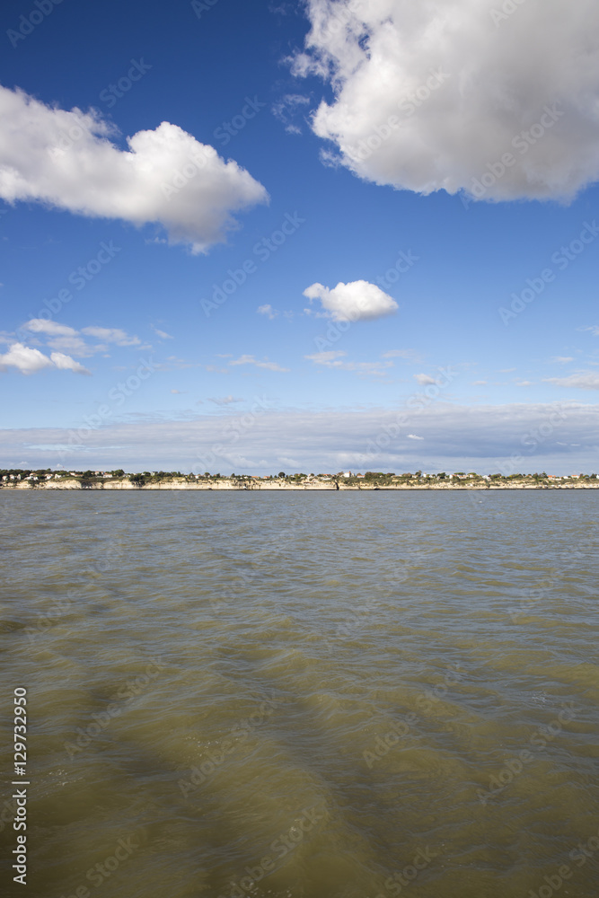 View of the coastline with seaside resort of Royan with blue sky and fluffy white cloud, France View of the coastline with seaside resort of Royan with blue sky and fluffy white cloud, France