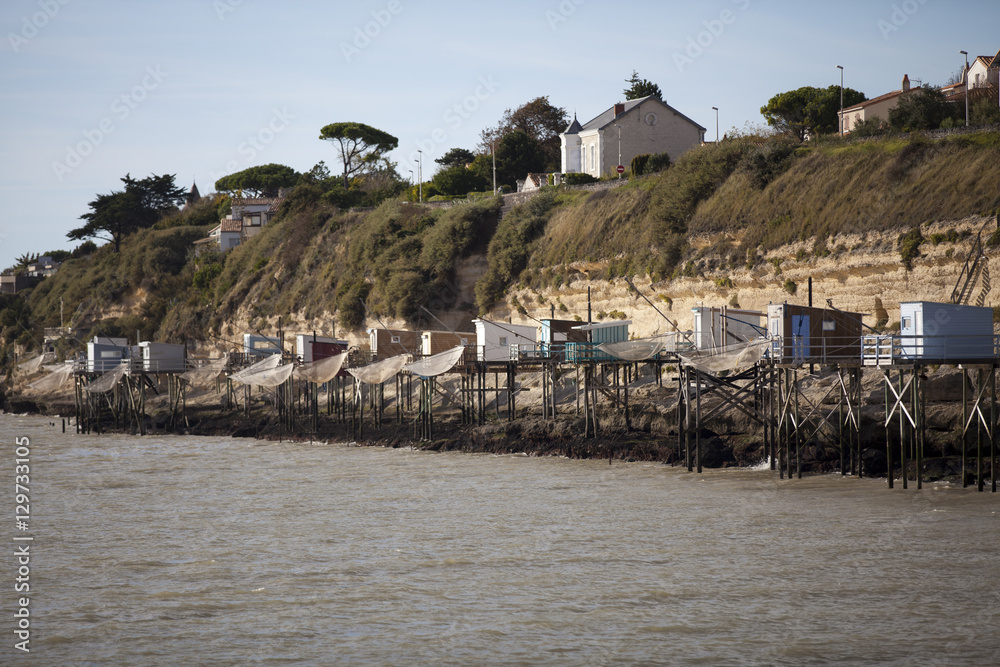 traditional french fisherman's wooden hut at the bottom of the limestone cliff in the estuary of Gironde, Meschers-sur-Gironde