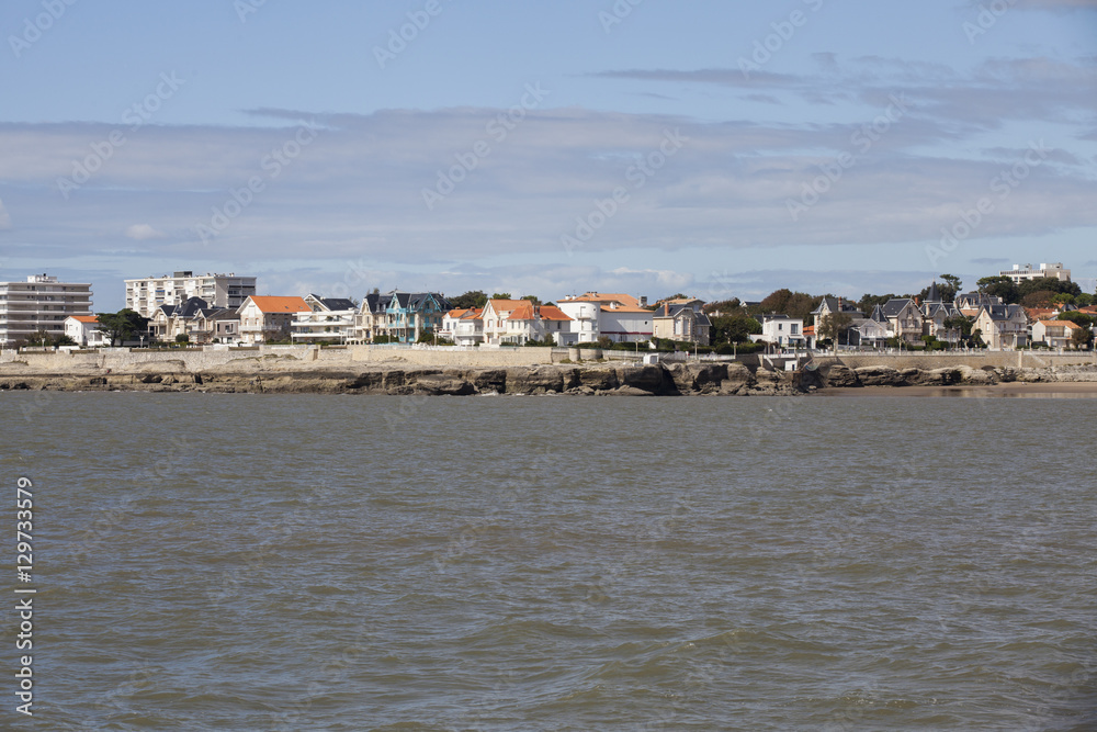View of the coastline with seaside resort of Royan with grey tourmented sky, France