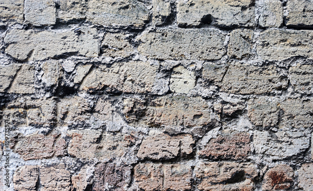 Fototapeta premium Old wall of scratched bricks