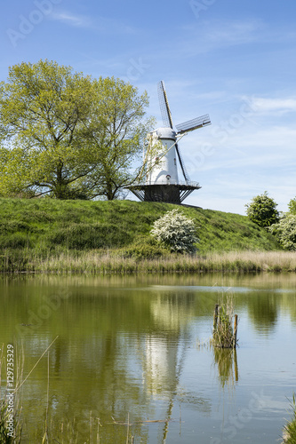 Typical Dutch landscape with a canal and a windmill