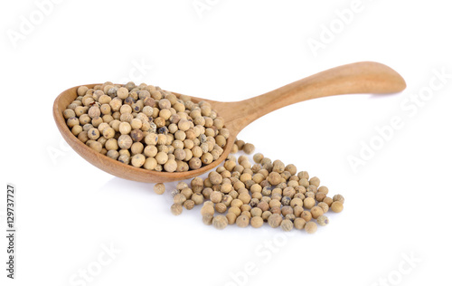 dry pepper in wooden spoon and on white background