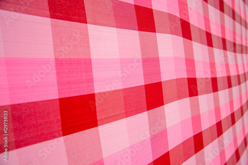 Close-up detail of pink and red striped cloth at an angle, Nakhon Ratchasima, Thailand. Thai textiles and background concept.