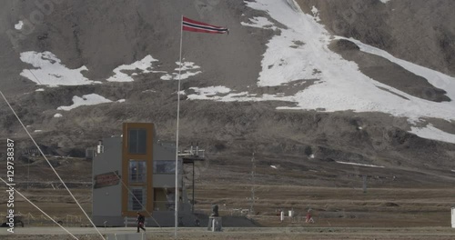 Norwegian Flag flies above Ny-Ő…lesund photo