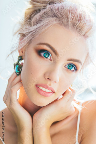 Close up portrait of beautiful young woman with blond hair and b