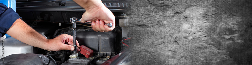 Hands of car mechanic with wrench in garage. Hands of car mechanic with wrench in garage.