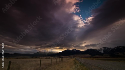 Absaroka mountains at sunrise over dirt road in Montana photo