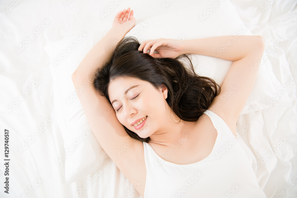 beautiful happy Asian woman lying on bed comfortable and blissfu beautiful happy Asian woman lying on bed comfortable and blissfu