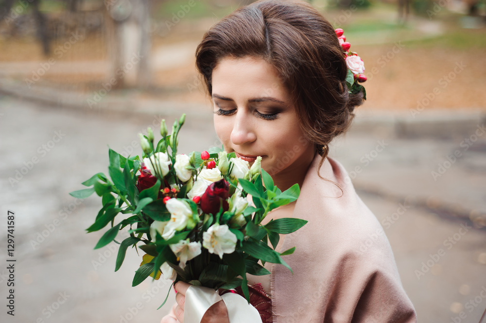 portrait of a beautiful bride in a red dress with a wedding bouq portrait of a beautiful bride in a red dress with a wedding bouq