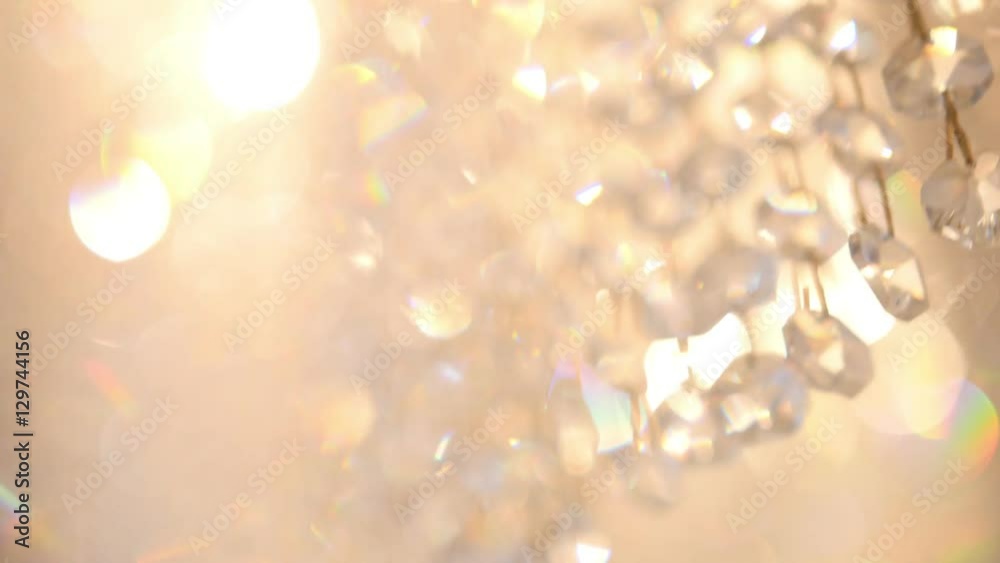 Crystal luxury fashion chandelier with shining reflection, defocused background