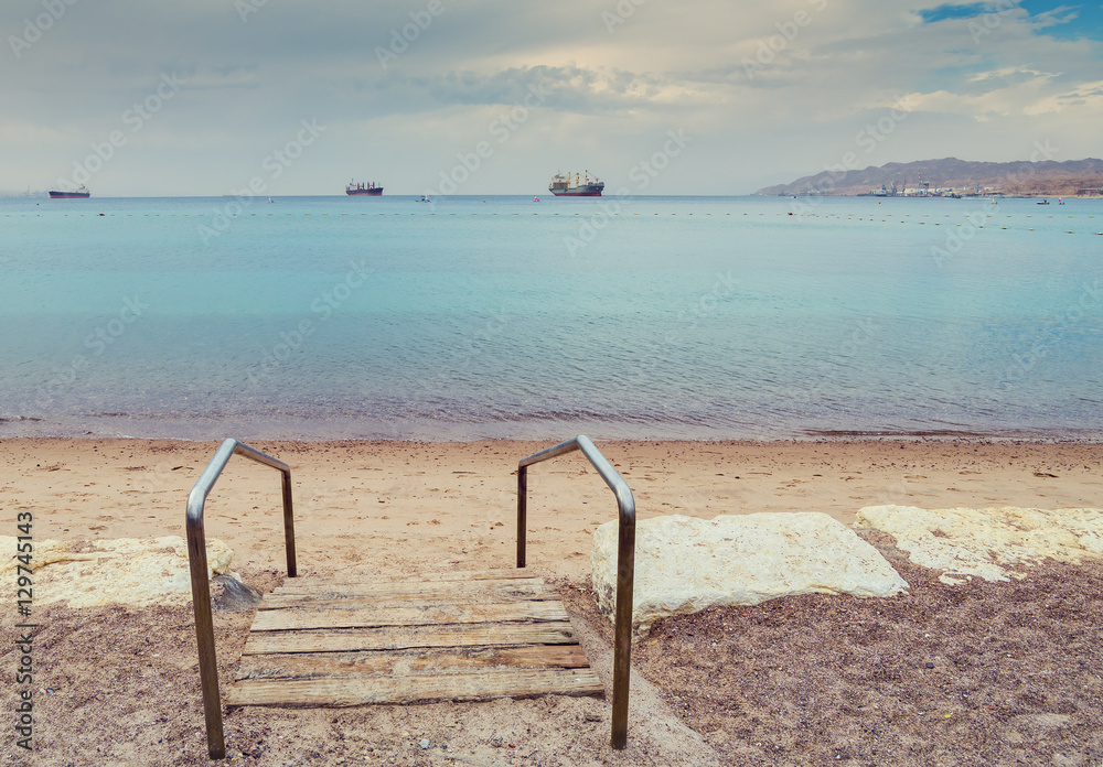 Sandy beach of Eilat - famous resort and recreation city in Israel Sandy beach of Eilat - famous resort and recreation city in Israel