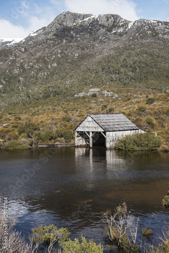 Boat shed in Dove Lake, Tasmania on a snowy and overcast day.