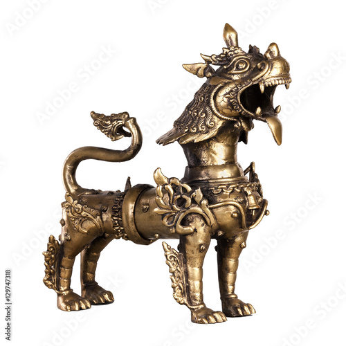 The growling snow lion - the figurine made of bronze in traditional Chinese style, isolated on a white background. 
