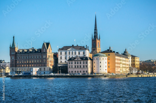 Panoramic view of the Old Town Riddarholmen island of Stockholm from Kungsholmen island. Birger Jarls white tower against clear sky © bortnikau