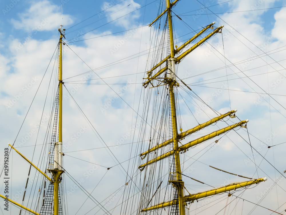 Masts of the ancient sailing ship on the blue sky background Masts of the ancient sailing ship on the blue sky background