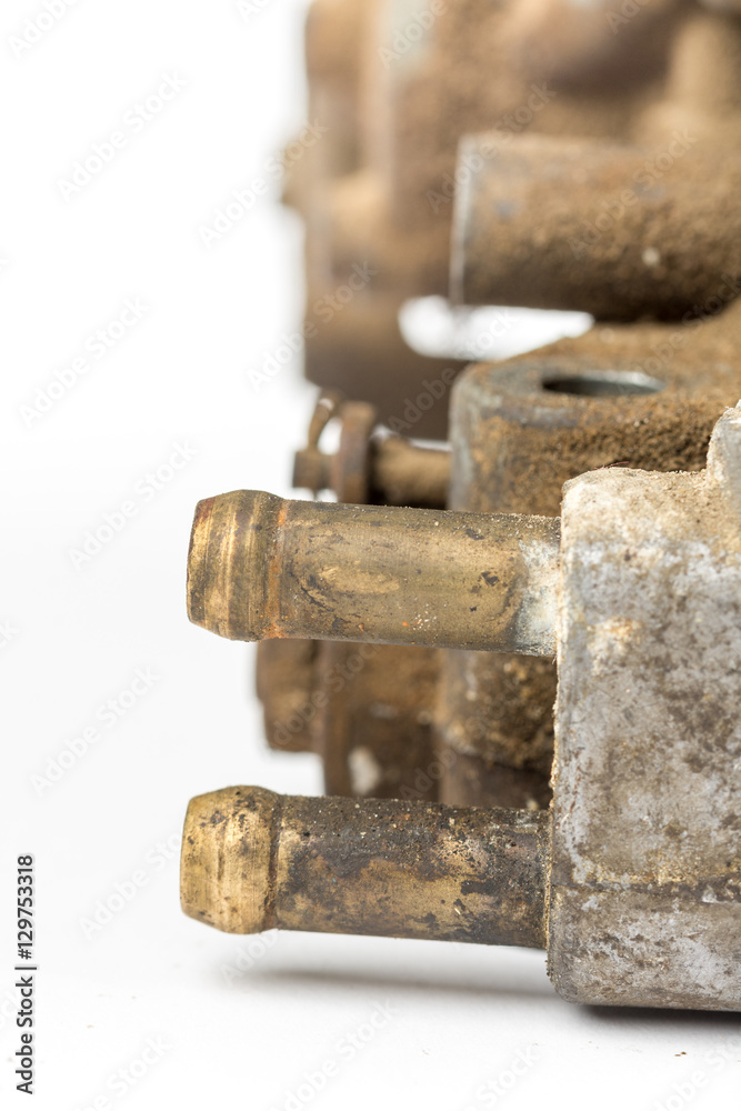 Old used dirty carburetor over white background Old used dirty carburetor over white background