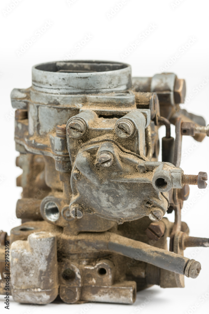 Old used dirty carburetor over white background