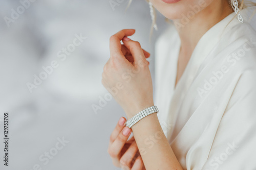 the bride wears a bracelet on hand