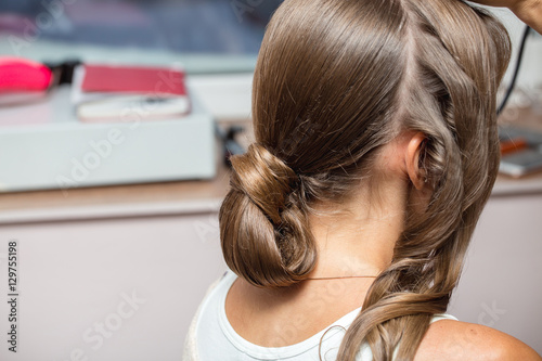 closeup of hands doing wavy hair style