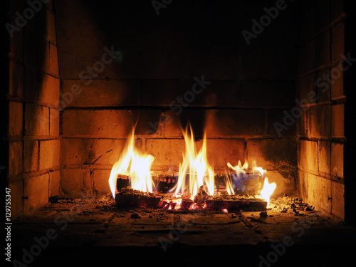 The fire in the fireplace. Firewood, charcoal, flames