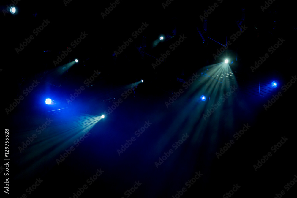 The light of searchlights in smoke on stage of the theatre