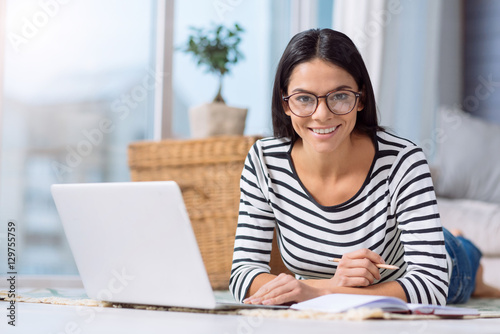 Pleasant woman using the laptop at home Free Download Pleasant woman using the laptop at home - GFXLoad