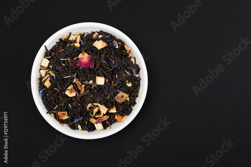 Loose tea leaves isolated on black background