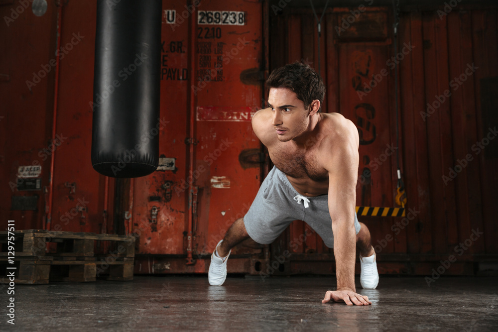 Photo of strong man make sport exercises.