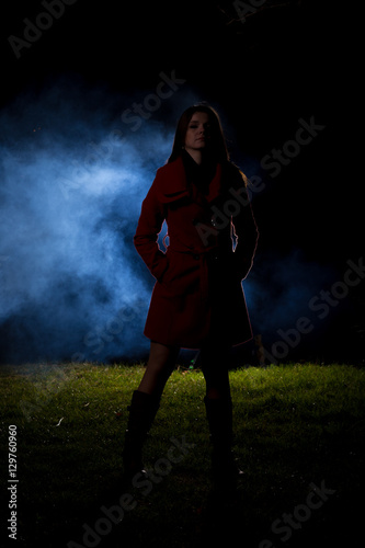 spooky silhouette girl at night with smoke in background
