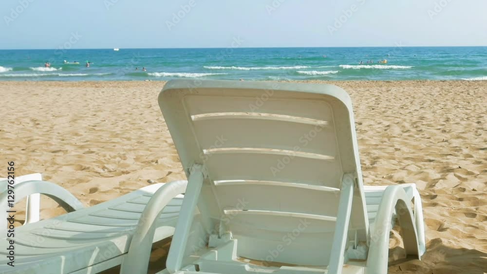 White chairs are placed on the beach for people to relax or sunbath. Beaches make a wonderful vacation spot. One of the most beautiful sceneries. White chairs are placed on the beach for people to relax or sunbath. Beaches make a wonderful vacation spot. One of the most beautiful sceneries.
