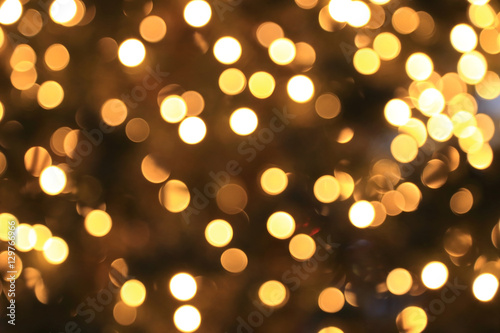 Abstract Christmas background, golden circular bokeh of lights.