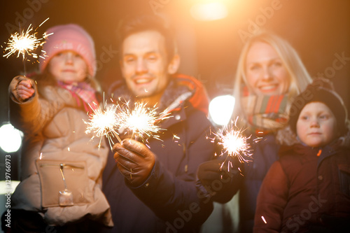 Happy family with bengal lights