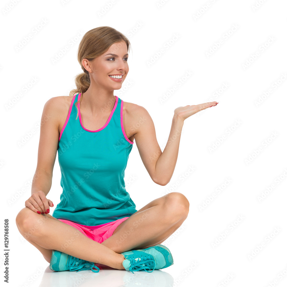 Sitting Woman In Vibrant Sports Clothes Presenting Sitting Woman In Vibrant Sports Clothes Presenting