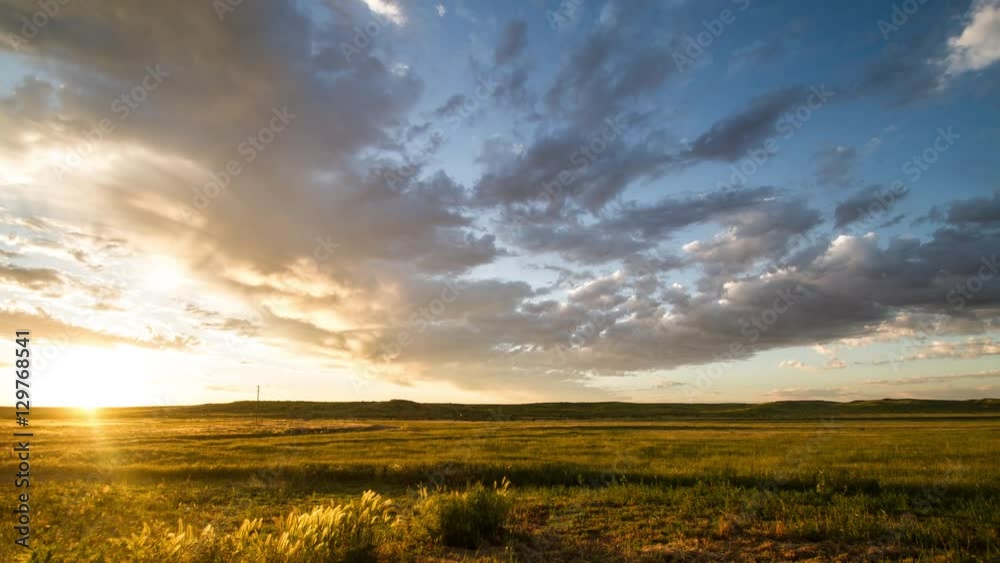 Time lapse - Clouds race towards rising sun on prairie morning