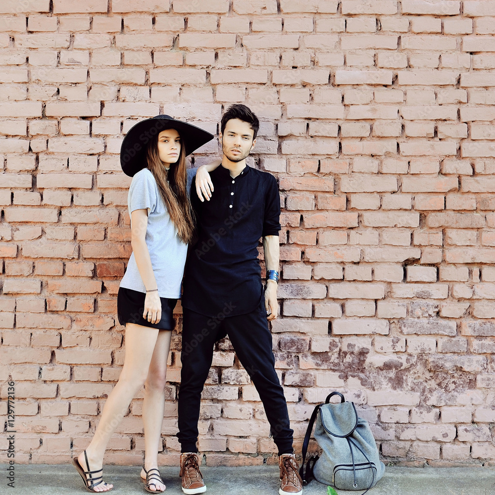 Outdoor fashion portrait of a beautiful young couple