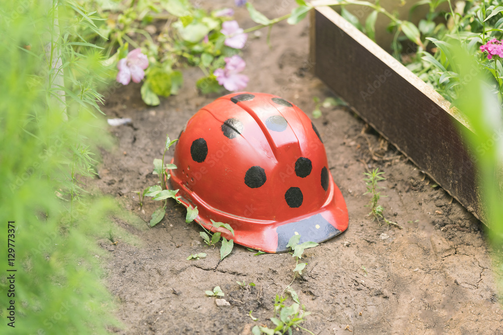 Red ladybird made from construction helmet in the garden Red ladybird made from construction helmet in the garden