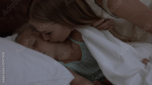 Cute little girl is lying in bed
