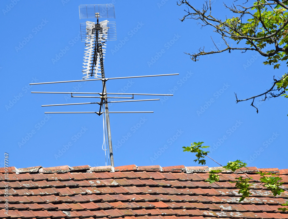Television antenna on the roof of an old house Television antenna on the roof of an old house