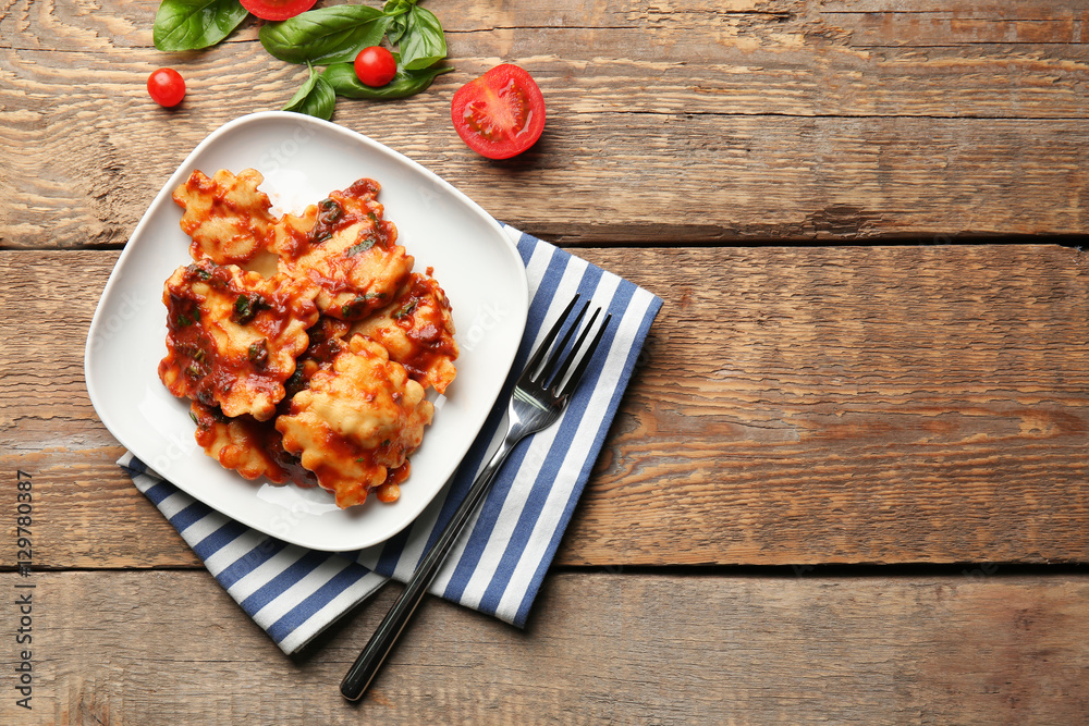 Plate of ravioli with tomato sauce on table Plate of ravioli with tomato sauce on table