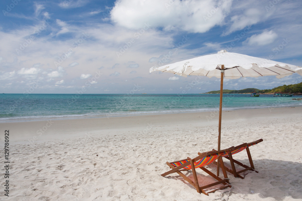 Beach chairs on the white sand beach.