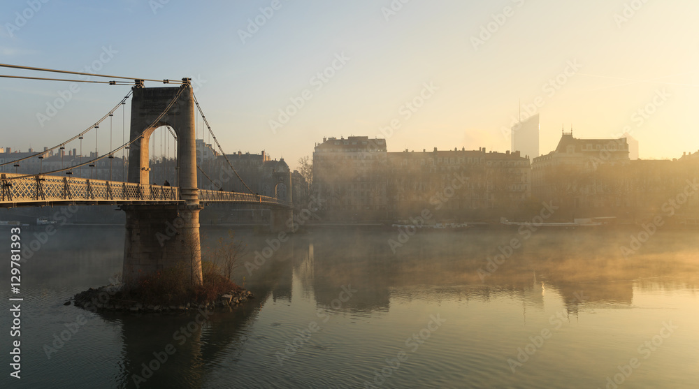 Fog over the Rhone river in Lyon during an autumn sunrise.